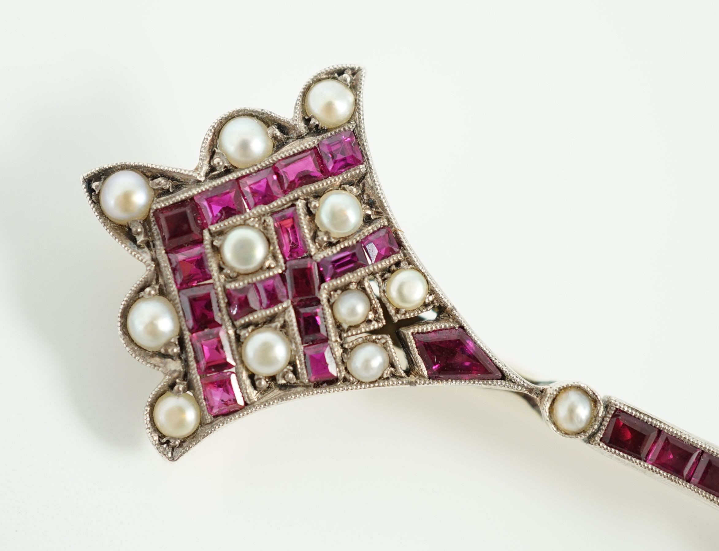 An early 20th century, gold, platinum, ruby and seed pearl set brooch